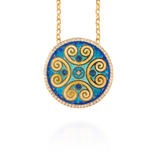 Gold and blue circular pendant necklace on a white background