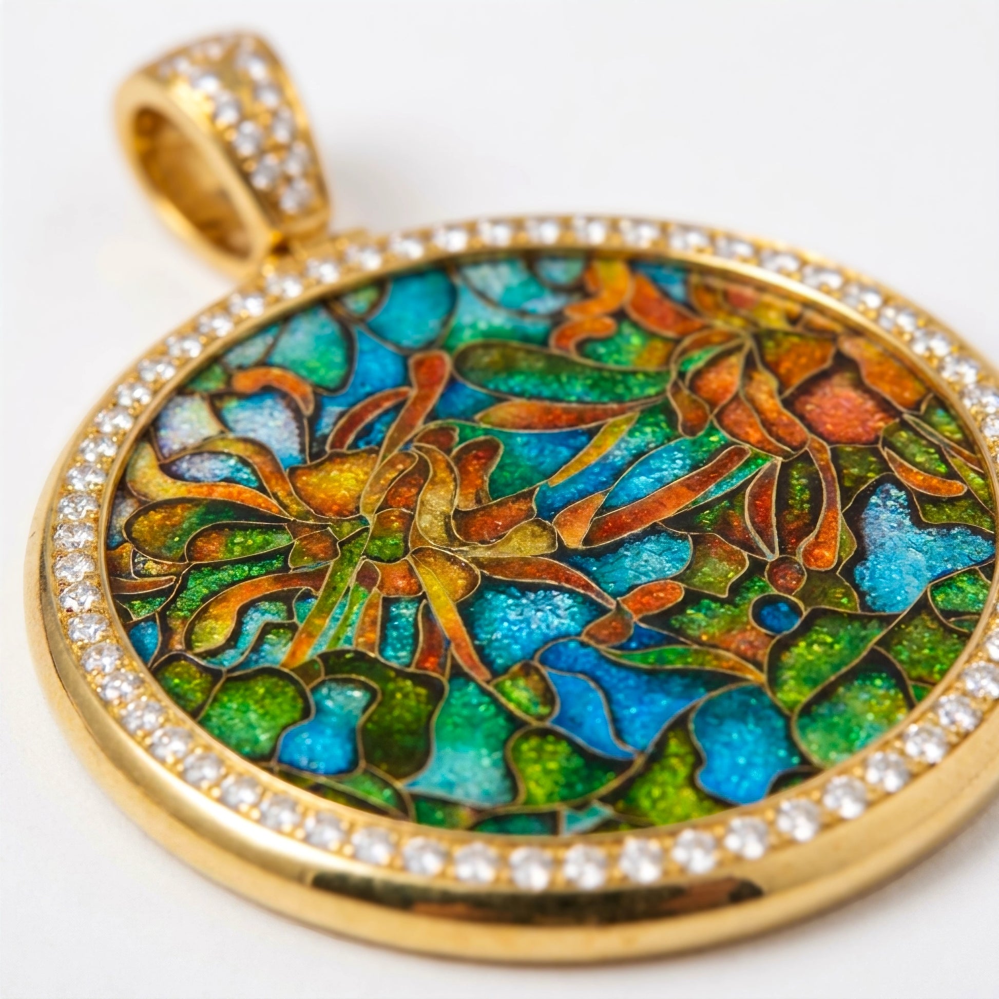 Colorful floral pendant with gold frame and gemstones on a white background
