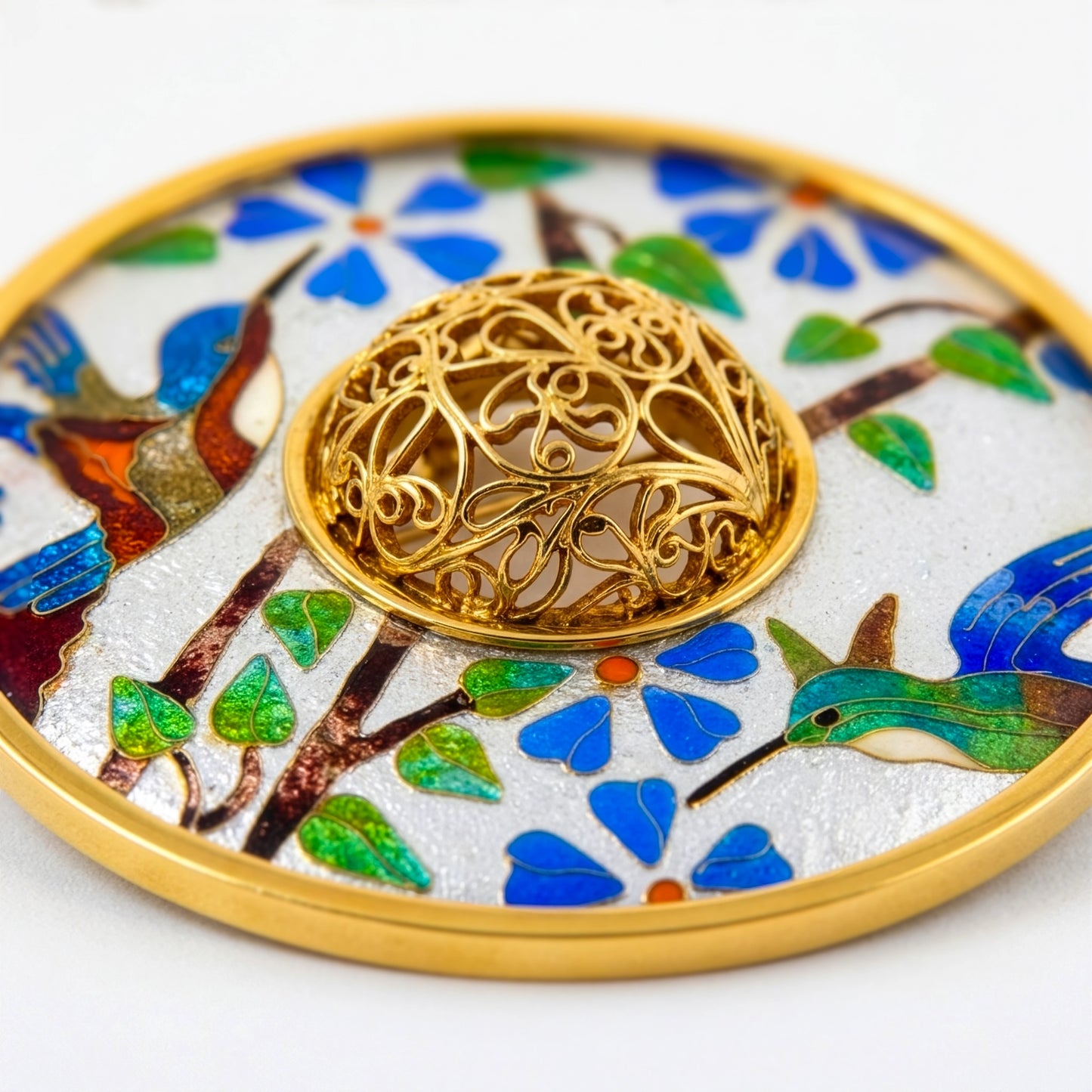Decorative plate with intricate gold design and colorful birds and flowers on a white background