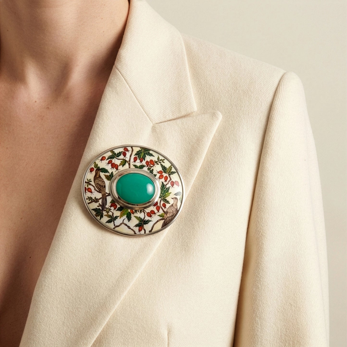 Close-up of a decorative brooch on a beige blazer