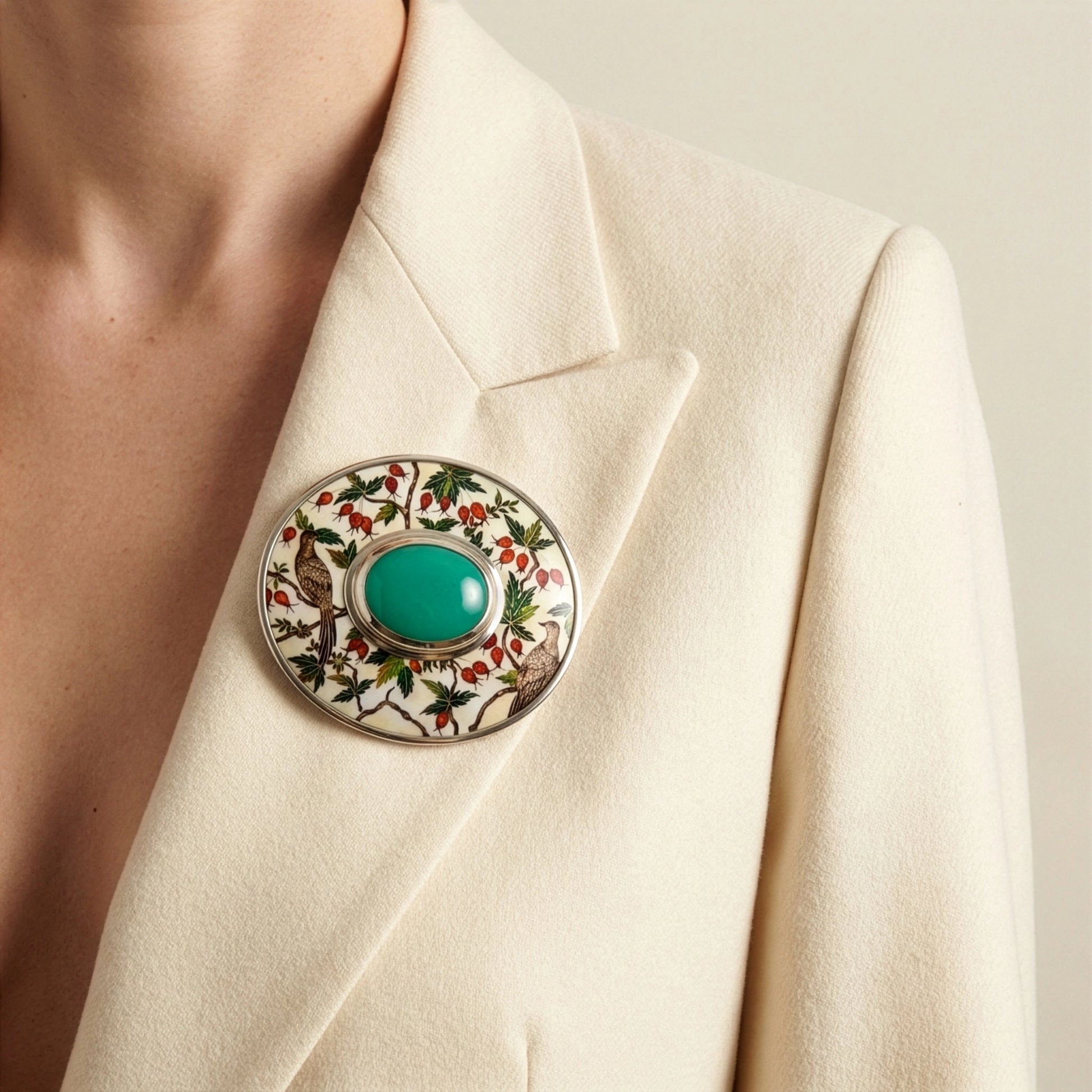 Close-up of a decorative brooch on a beige blazer